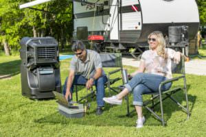 couple enjoying their RV next to a Portacool evaporative cooler